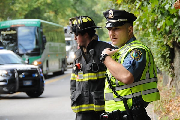 Police officer and fire fighter at the scene of an accident