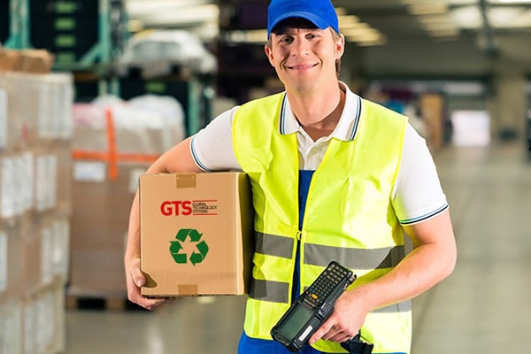 Warehouse employee carries a box of recycled batteries
