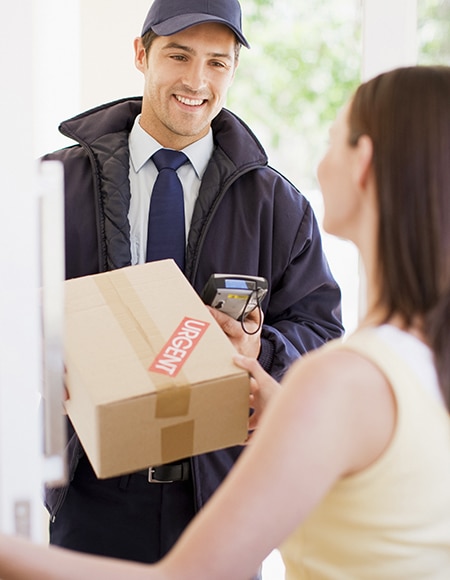 package delivery driver handing package to woman